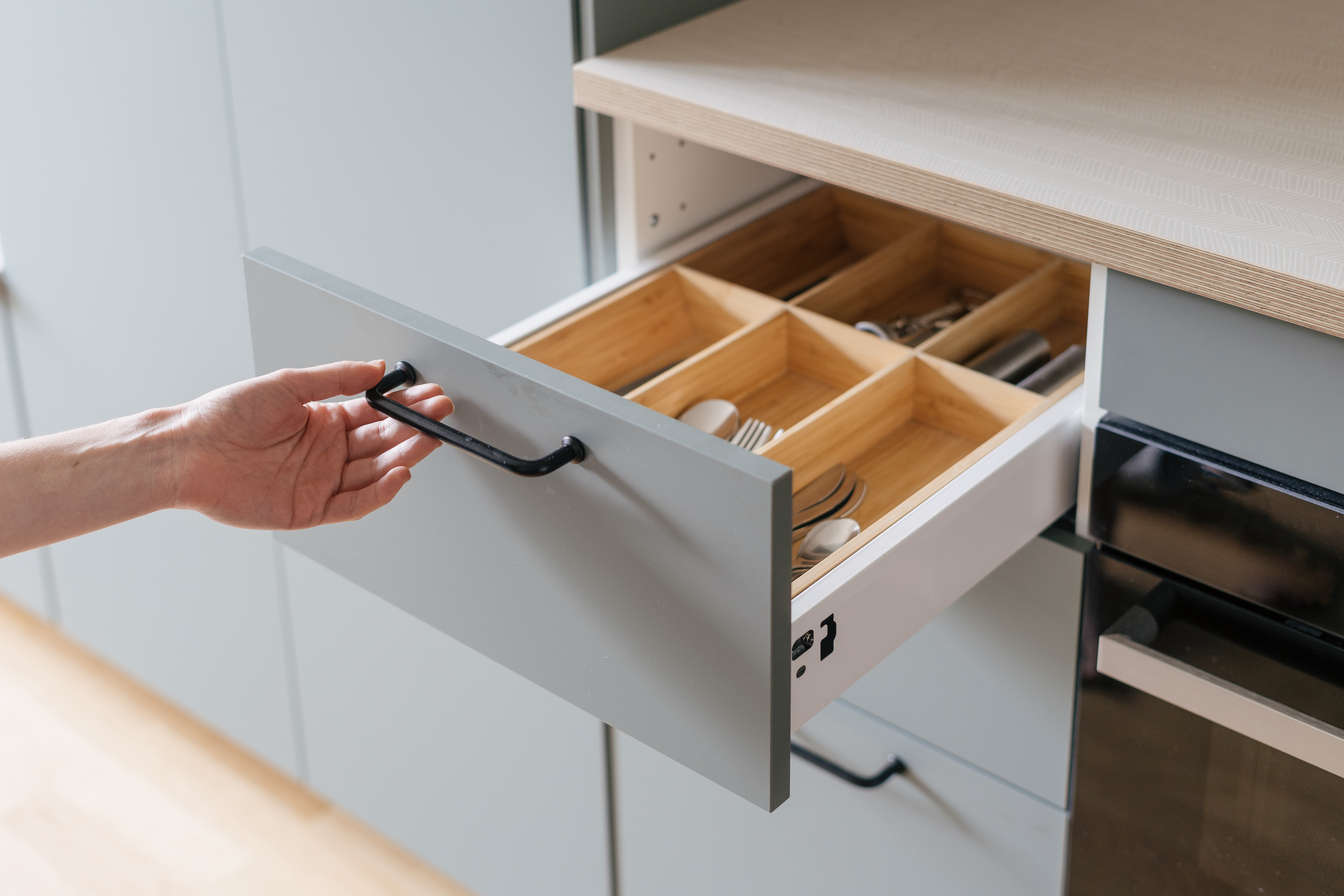 Opening and closing the kitchen drawers.